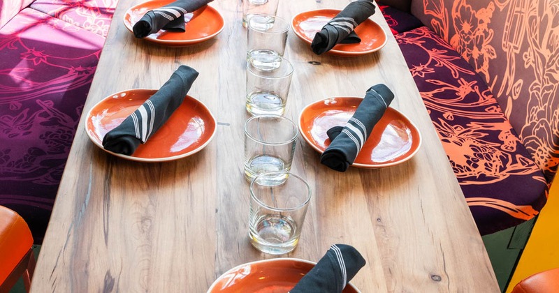 Dining table with plates, napkins and glasses