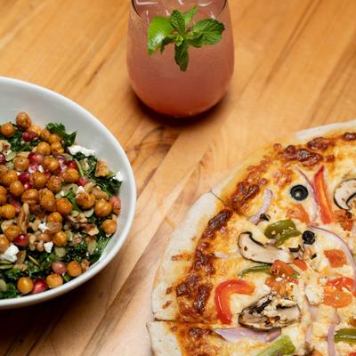 Power salad bowl, veggie pizza and a red mixed drink.
