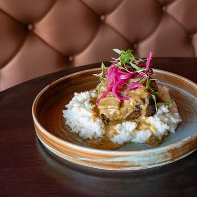 Braised short rib, on a bed of white rice.