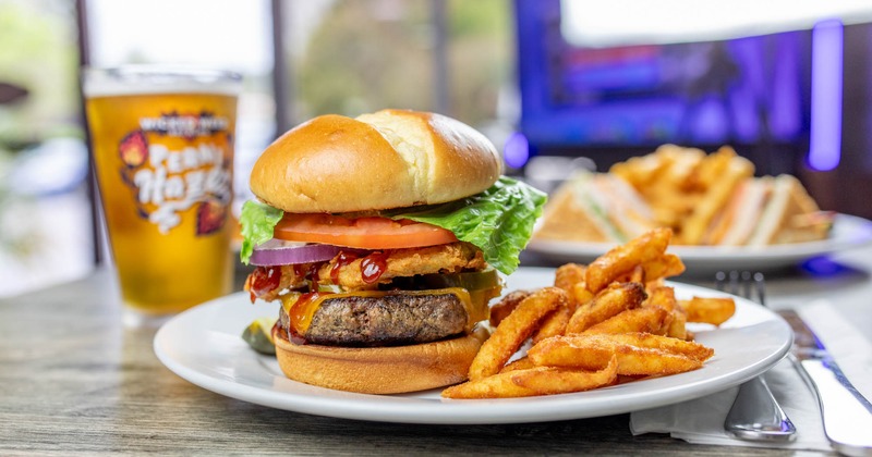 Tex Mex burger, with crispy onions, jalapenos, BBQ sauce, cheddar, lettuce, tomato, and onion