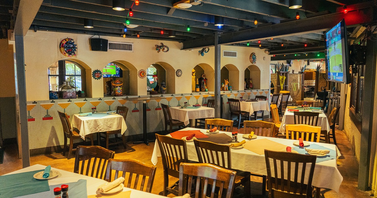 Spacious and cozy interior dining area with dining tables set for guests