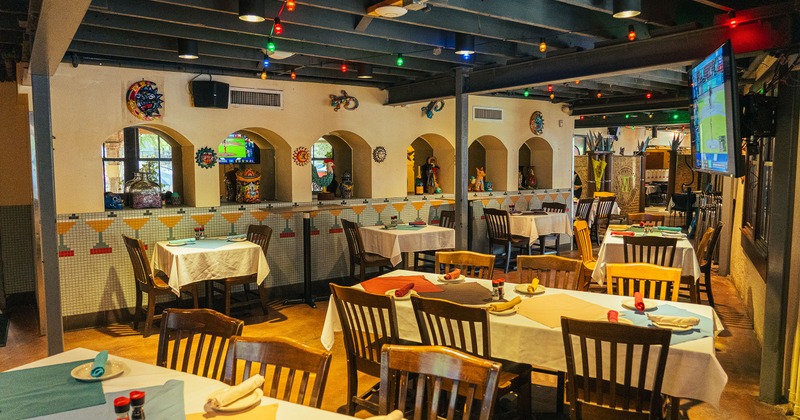 Spacious and cozy interior dining area with dining tables set for guests