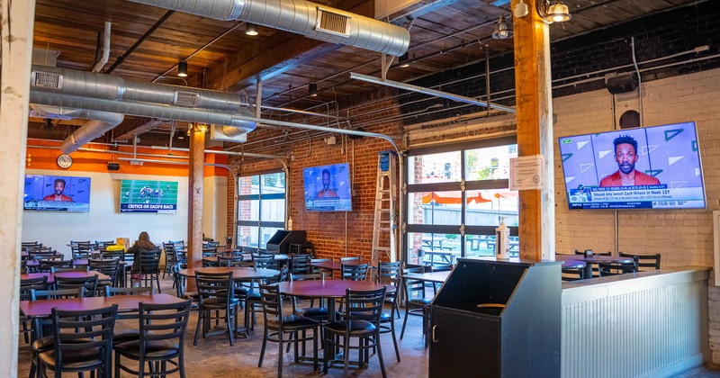 Seating area with TVs on walls