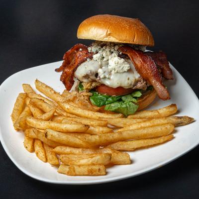 Cordon Bleu Sandwich topped with bacon and blue cheese crumbles, served with fries.