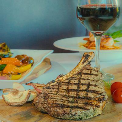 Grilled ribeye steak and a glass of red wine.