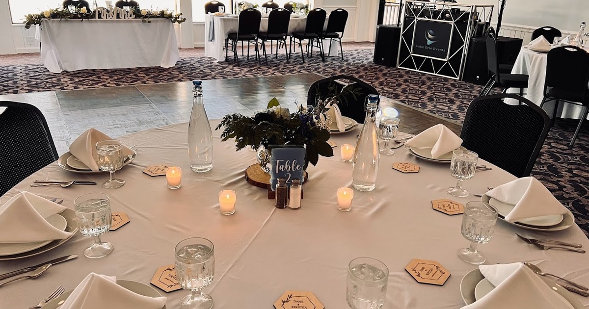 A ballroom with tables and candles overlooking the 18th green.