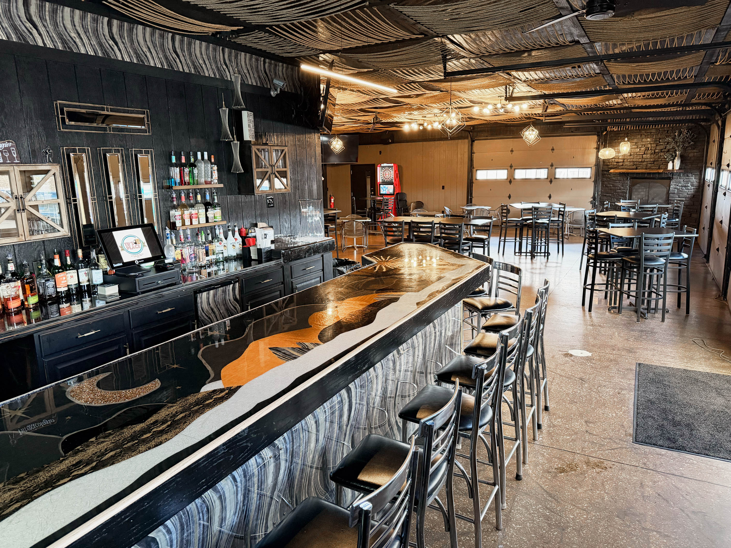 Party room, bar area featuring a custom epoxy bar top with a scenic design
