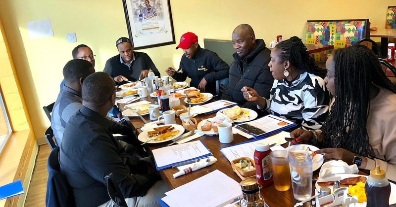 A group of people having a breakfast meeting in a restaurant