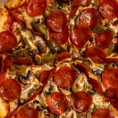 Pizza with pepperoni, cheese, mushrooms, and jalapenos.