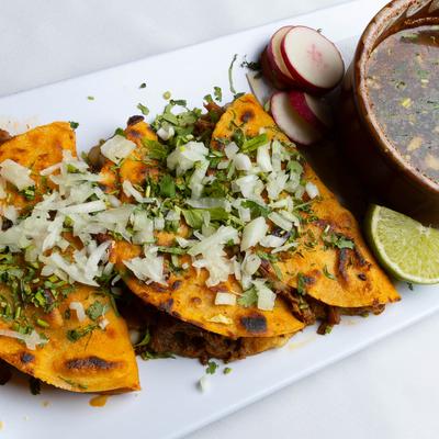 Birria tacos, with onions and cilantro.
