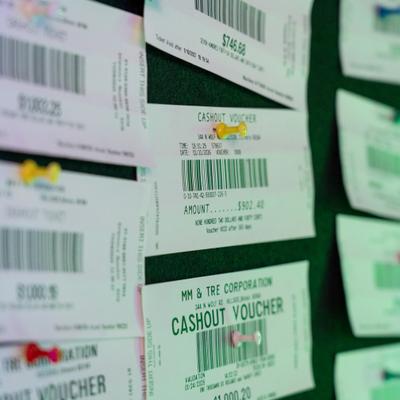 Close-up of cash-out vouchers on a board.