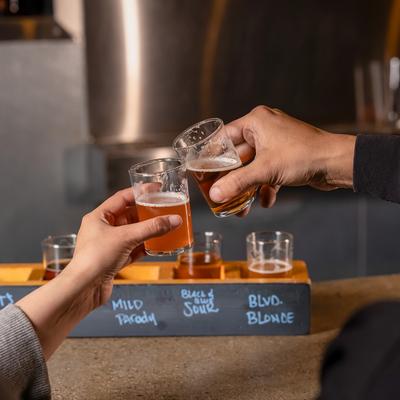 Hands toasting with their glasses.