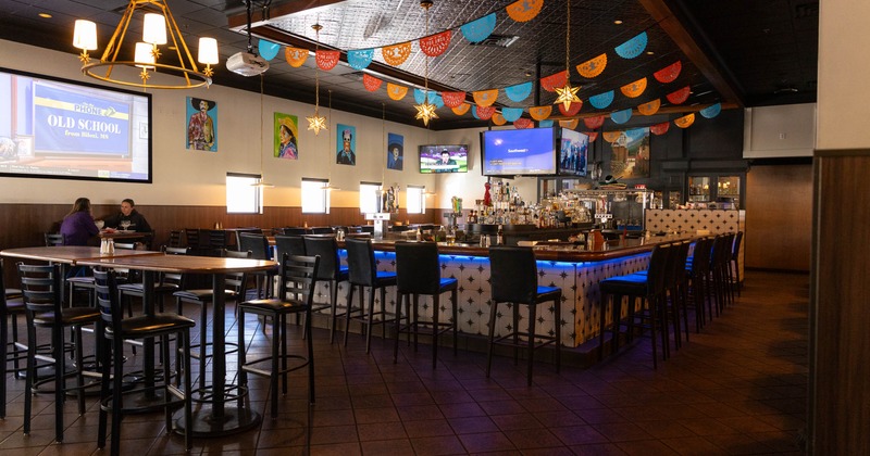 Interior, tables and chairs ready for guests with bar in the middle