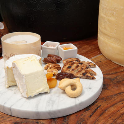 Cheese platter with focaccia, dried apricot, and condiments