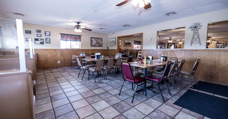 Cozy diner interior with empty wooden chairs around tables
