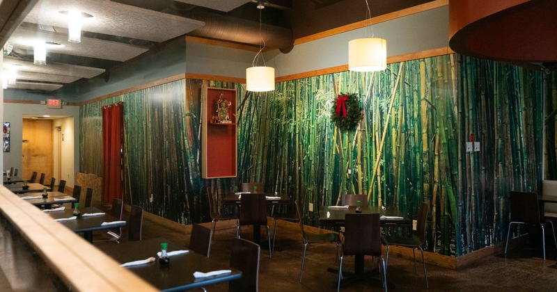 Interior, dining area, tables for four, ready for guests, bamboo wallpaper