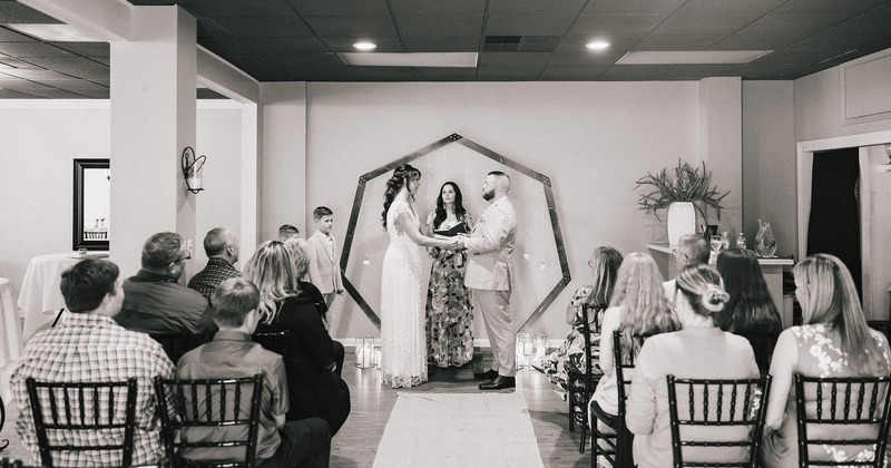 Black & White photo of a bride and groom with onlooking guests in our event space.