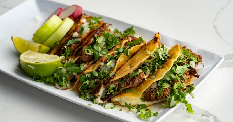 A plate of Taco Dorado De Carnitas