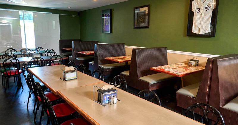 Interior, seating booths with tables, regular tables ready for guests, shop window