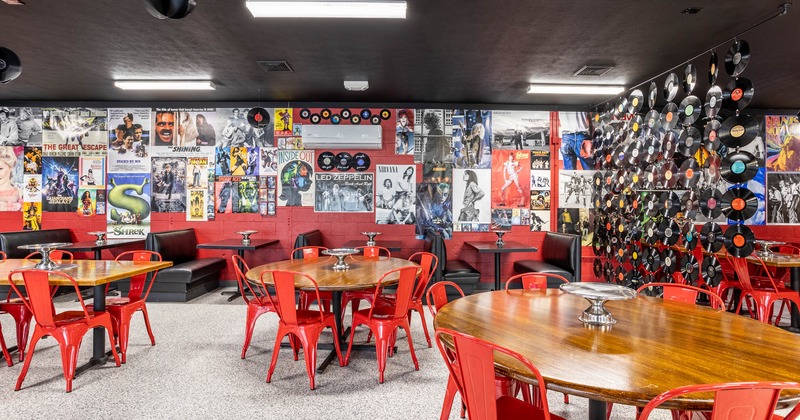 Seating area, room walls decorated with movie posters and vinyls