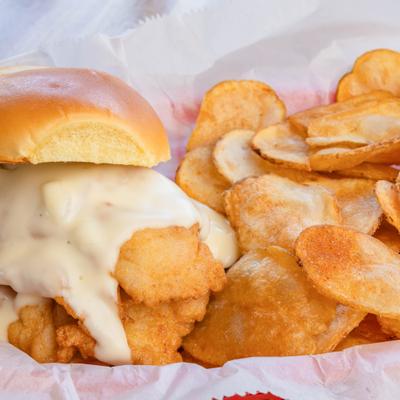 Grouper Special sandwich topped with cheese and served with chips.
