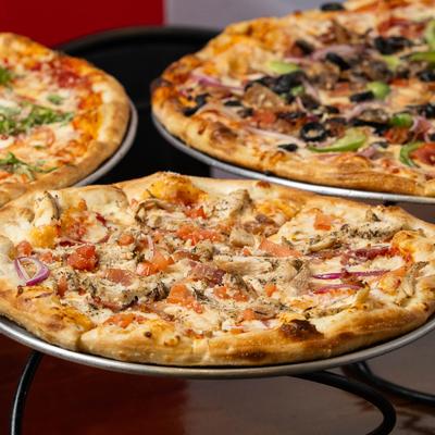 Assorted pizzas on a table.