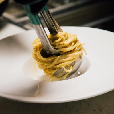 Staff member preparing spaghetti