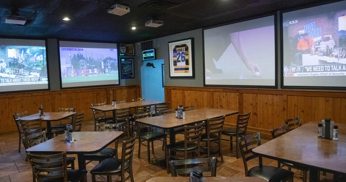 Seating tables and large TV screens on the walls
