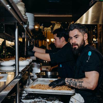 Chefs preparing crispy fried noodles.