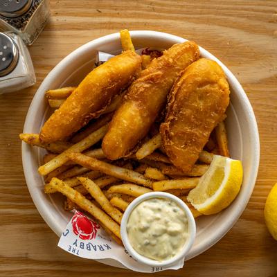 Fish and Chips served with tartar sauce and a lemon wedge, overhead view.