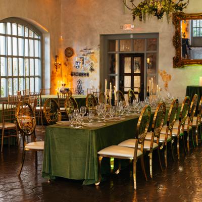 Reception table set with plates, glasses, candles and decorations.