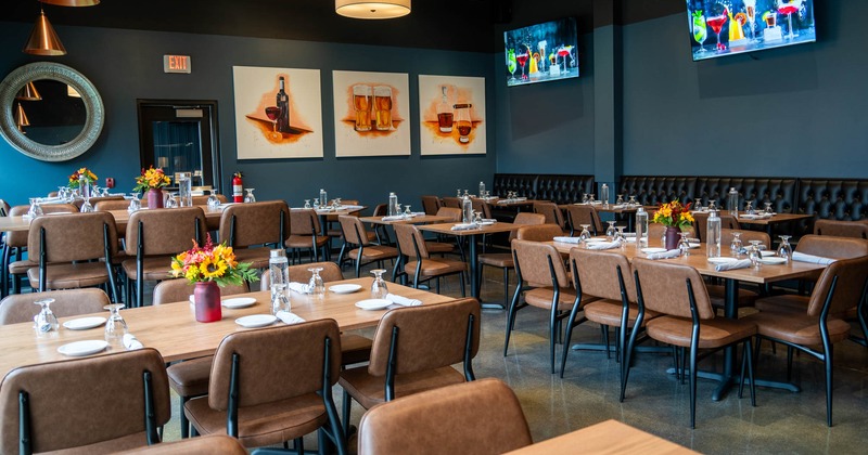 Interior, dining tables, two large TV screens on the wall
