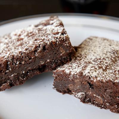 Chocolate brownies topped with powdered sugar.