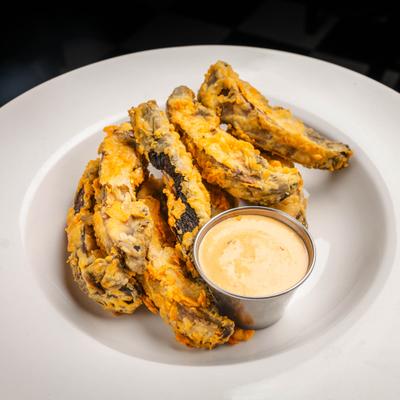 Portobello Fries served with a dipping sauce.
