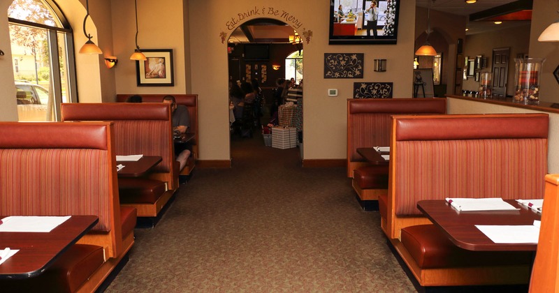 Interior, dining booths with tv on the wall in the back