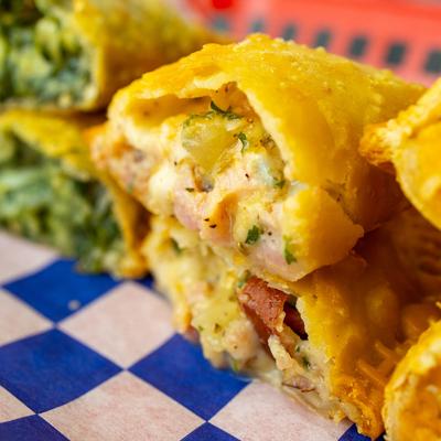 A close up of assorted empanadas.