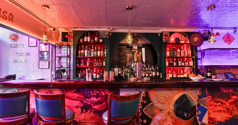 Bar, bar stools, drink rack behind