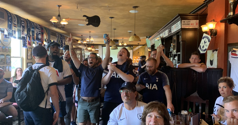 Interior, guests watching a game and cheering