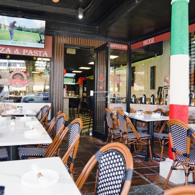 Outdoor dining area with set tables.