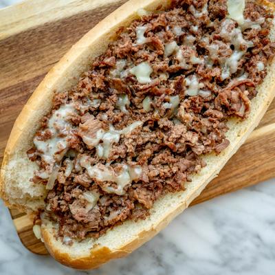 Cheesesteak sandwich with chopped beef and melted cheese.