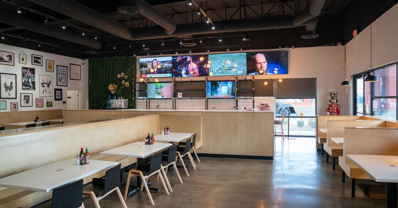 Interior, guest tables, bar, wall TVs above the bar