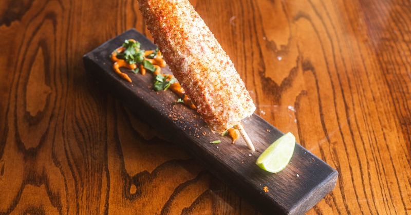 Street corn on the cob with mayo, cotija cheese, and tajin