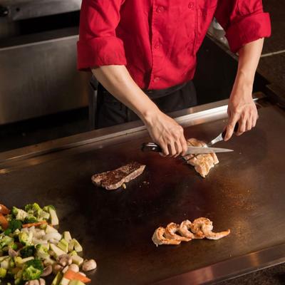 The staff member slicing food.