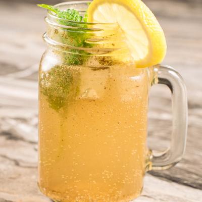 Masala soda served in a mason jar with mint  and lemon garnish.