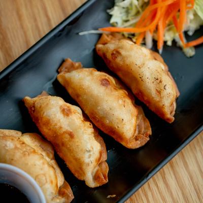 Served pot stickers on the plate.
