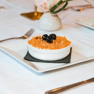 Italian frozen dessert topped with amaretti crumbs and cherries.