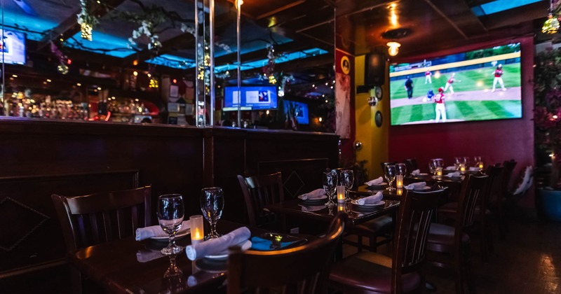 Interior, bar area with tables with tableware and glasses