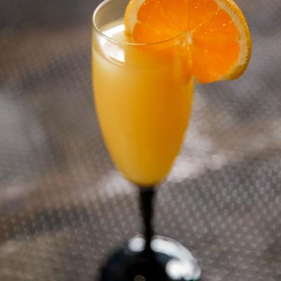 Mimosa, garnished with orange wedge