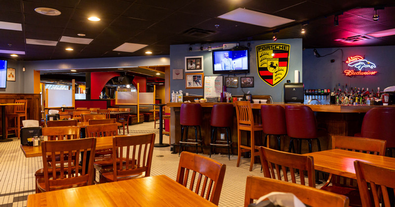 Interior, guest tables and chairs , bar, booths in the back