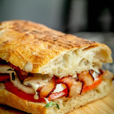 Italian BLT on a wooden board.